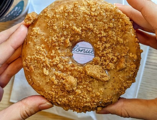 round vegan cake donut topped with coffee cake crumbs