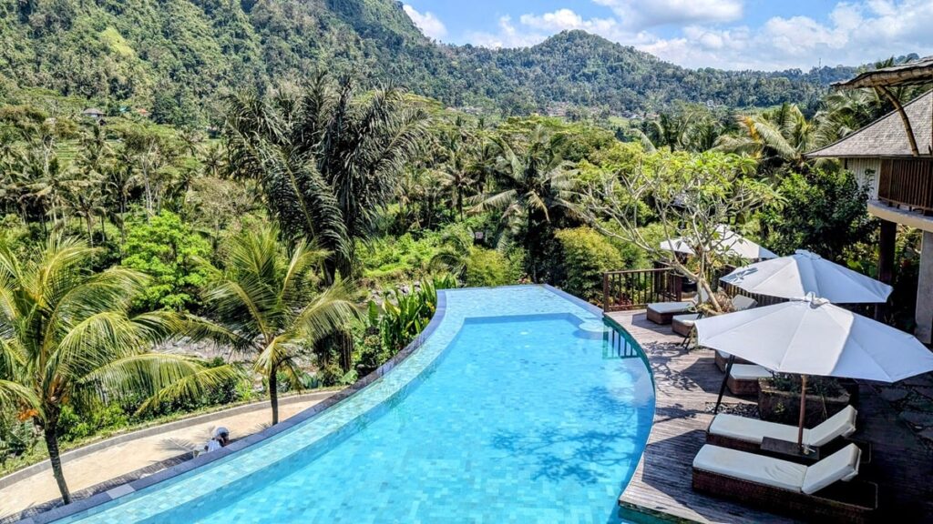 overhead view of the infinity pool surrounded by lush greenery at wapa di ume in sidemen 