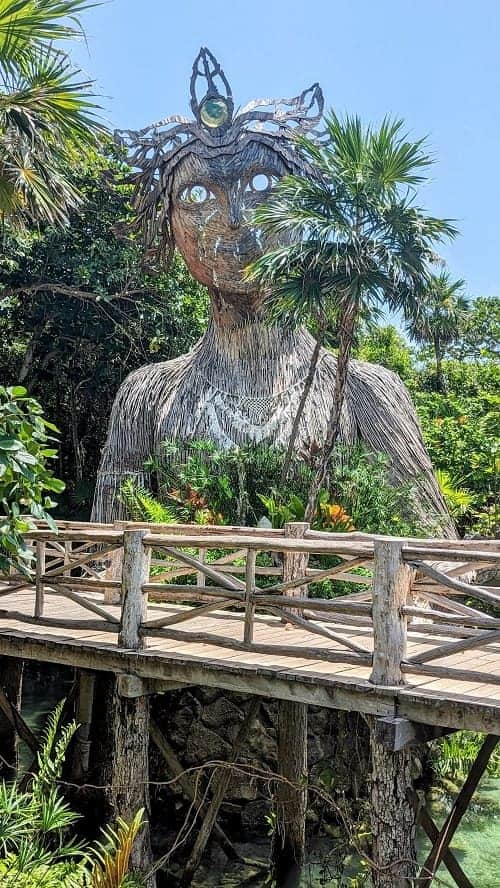 a woman made of wicker and wood who is considered the spirit of nature at the palmaia resort in playa del carmen