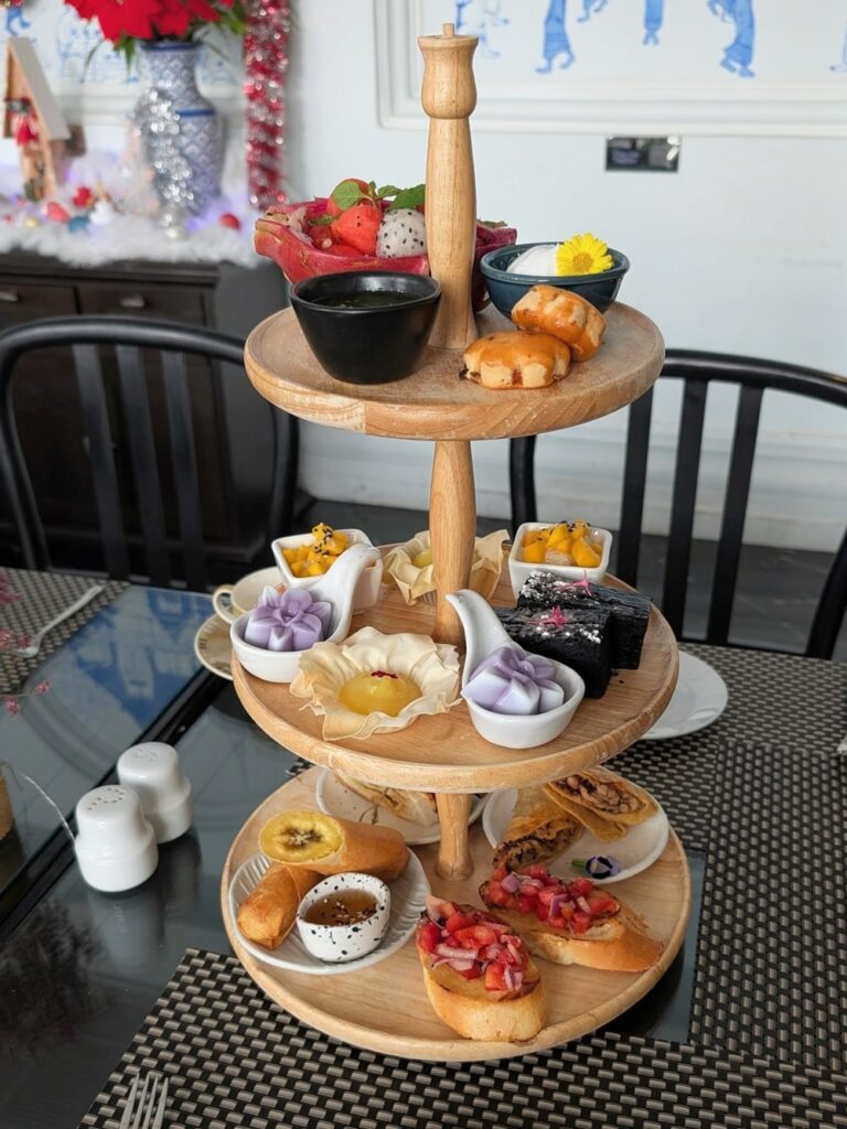 tiered tray with vegan cakes and sandwiches for high tea at away chiang mai vegan hotel in thailand