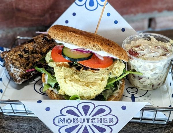vegan egg salad sandwich in a tray with potato salad and a granola bar from the vegan restaurant no butcher in las vegas