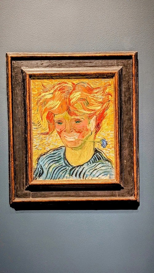 bright yellow and orange painting of a boy at the norton museum of art in west palm beach
