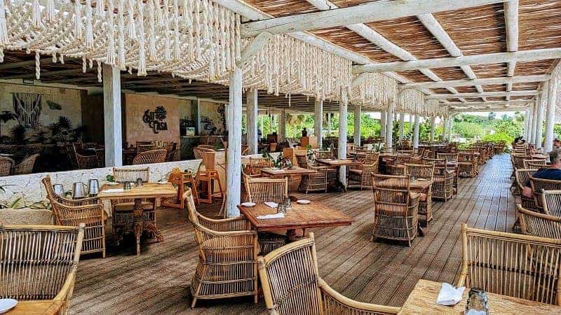 the laid back beachfront dining area with wicker chairs and rope accents at su casa at the palmaia resort in mexico