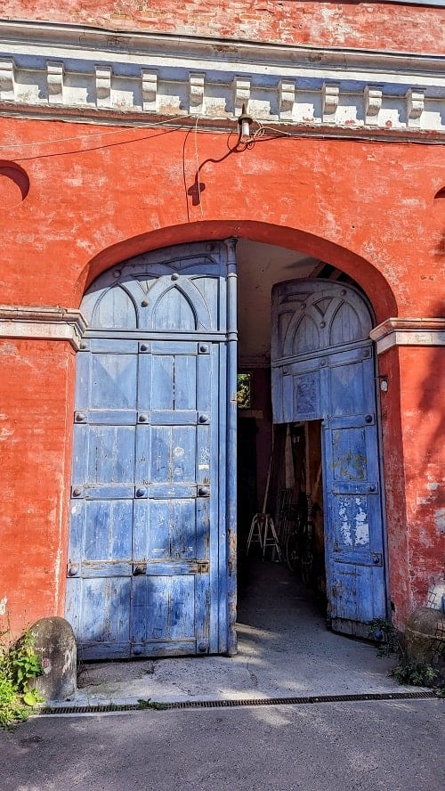a faded blue door on an orange building in Freetown Christiania