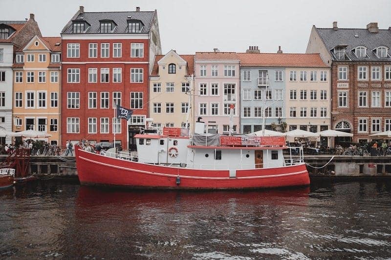 red and white boat in the copenhagen harbor
