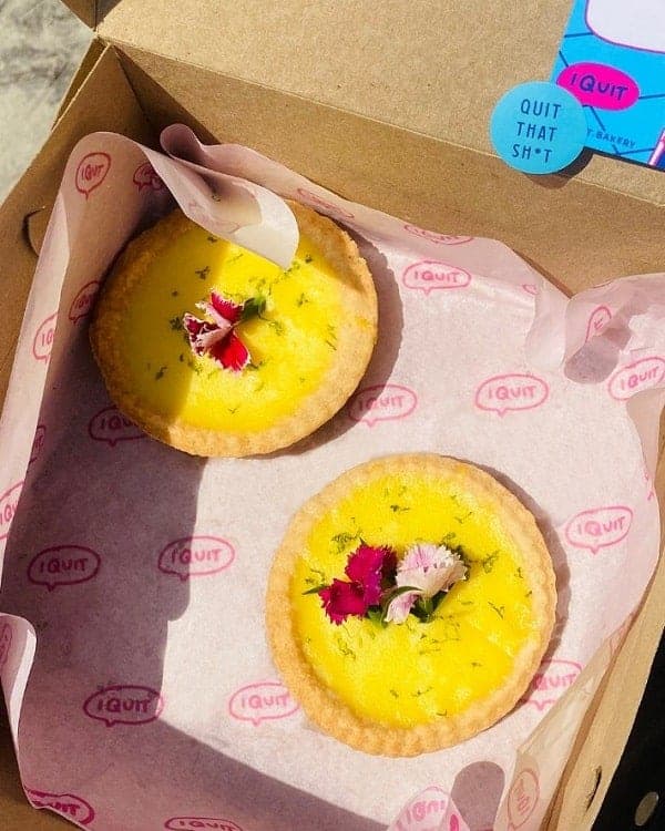 two vegan lemon tarts in a paper box from i quit vegan bakery in mexico city