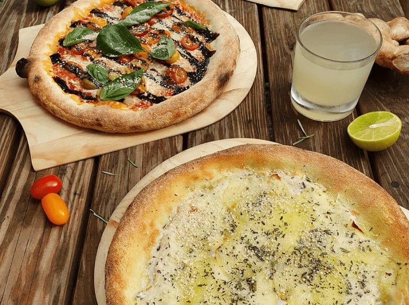 two vegan pizzas next to each other at pow vegan pizzeria in copehagen 