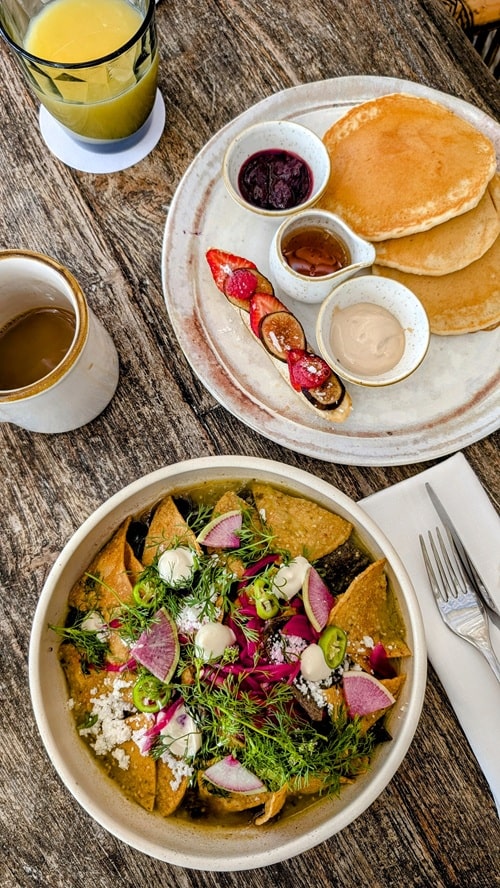 vegan chilaques and an order of golden pancakes with fresh orange juice and su casa at the palmaia resort