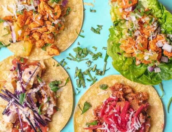 colorful vegan tacos spread out on a bright blue background