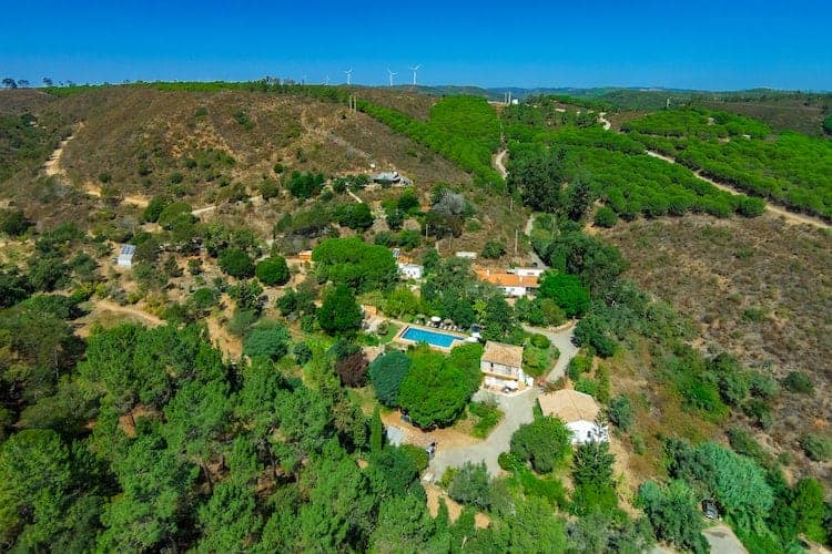 overhead view of the vegan-friendly yoga retreat Moinhos Velhos nestled amongst lush greenery in portugal
