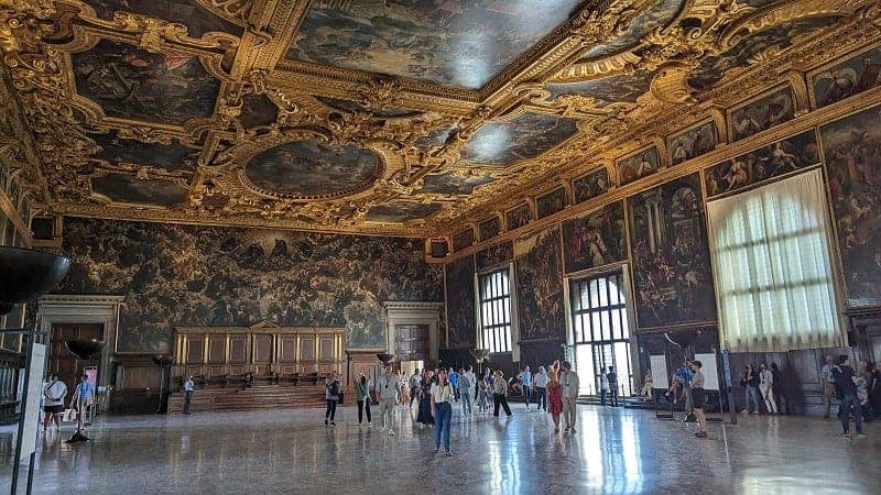 inside of doges palace with dark features and gold accents in venice
