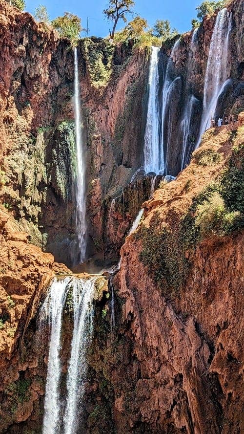 ouzoud waterfall between red rocks in morocco