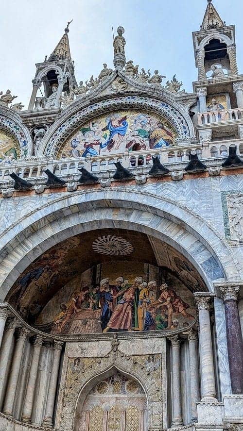 the marble and colorful mosaic entrance to st marks in venice