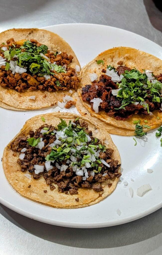 plate with three vegan tacos with chorizo and mushrooms at VEGuerrero in mexico city