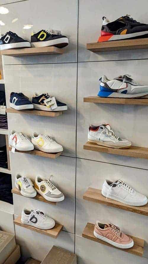 a display of vegan sneakers on a white wall at vunderland in hamburg