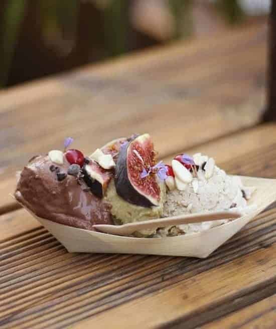 two scoops of vegan gelato in a paper boat topped with fresh slices of figs at raw firenze in florence