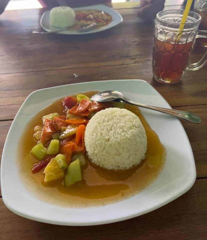 a white bowl filled with sweet and sour vegan rice at the shady shake in bali