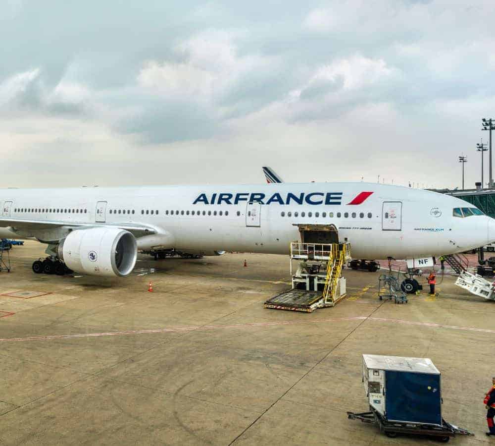 air france plane parked at an airport waiting to load luggage