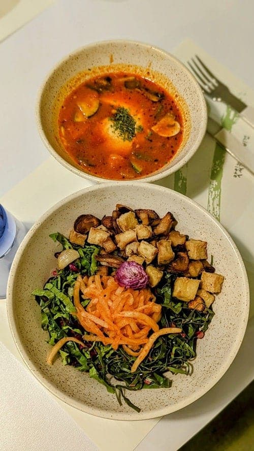 vegan bibimpab bowl next to a spicy soup at plantude in seoul