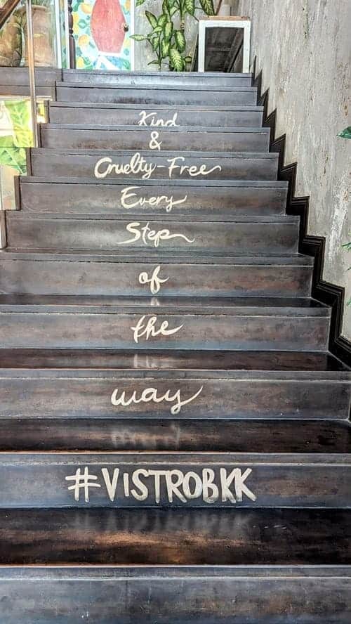 black stairs with a statement about living vegan and cruelty free on each stair