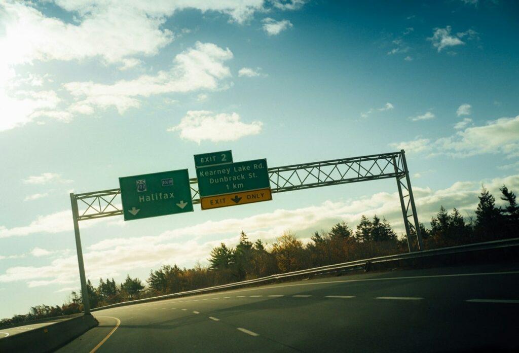 a sign on the highway directing two lanes towards halifax, nova scotia