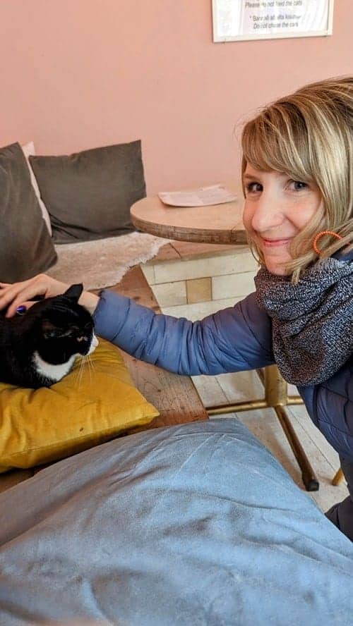 rebecca gade sawicki with a black and white cat in iceland
