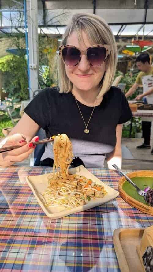 rebecca gade sawicki eating noodles with chopsticks in chiang mai