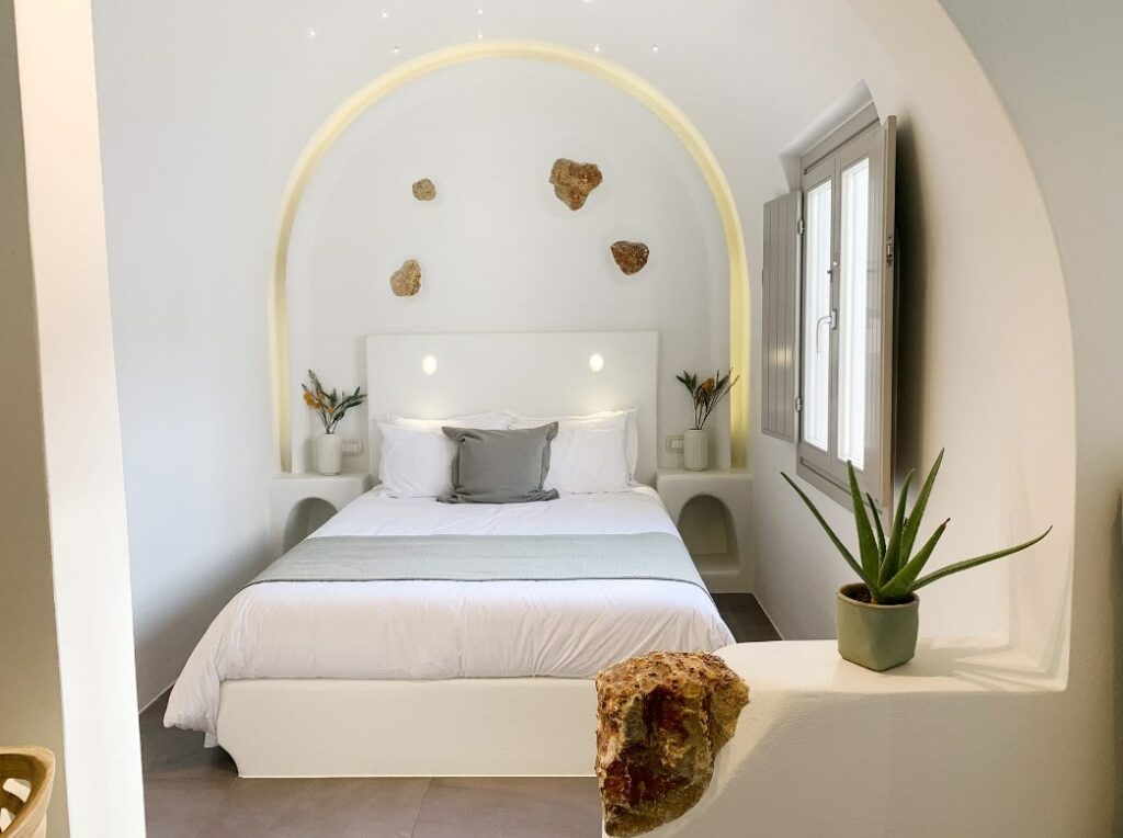 inside of a modern guestroom with white walls and neutral tones at the vegan hotel  mod santorini in greece