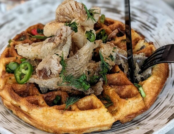 a vegan waffle topped with crispy mushrooms and maple syrup at planta in toronto at brunch