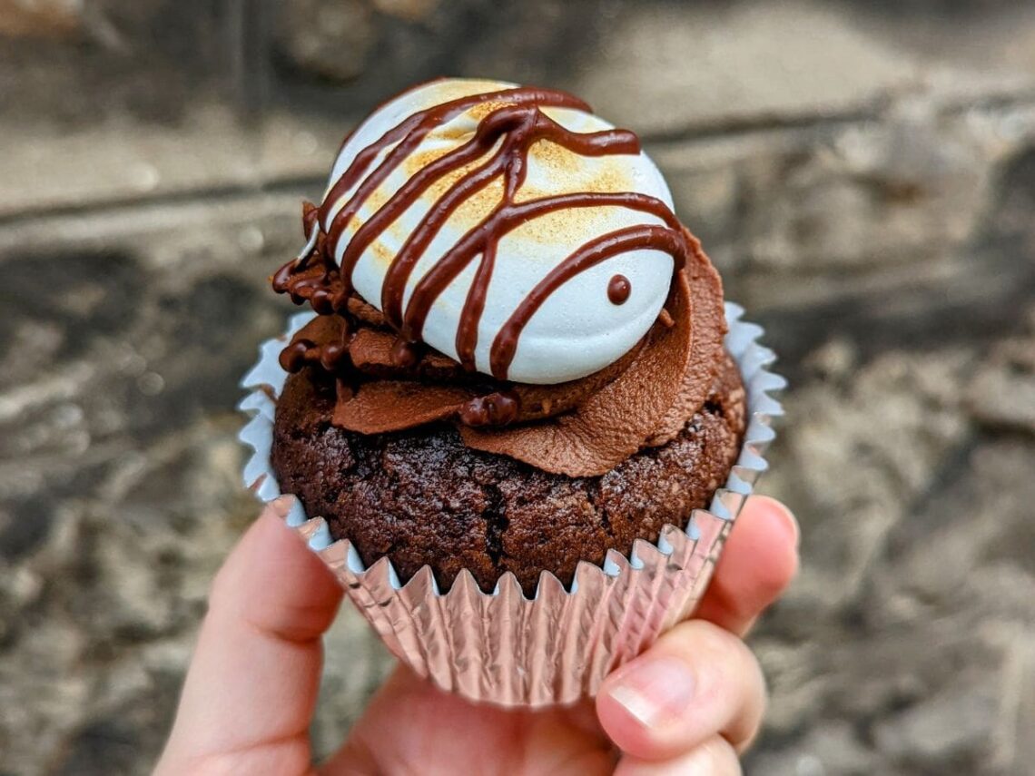 a single chocolate vegan cupcake topped with marshmallow fluff with a drizzle of chocolate in edinburgh