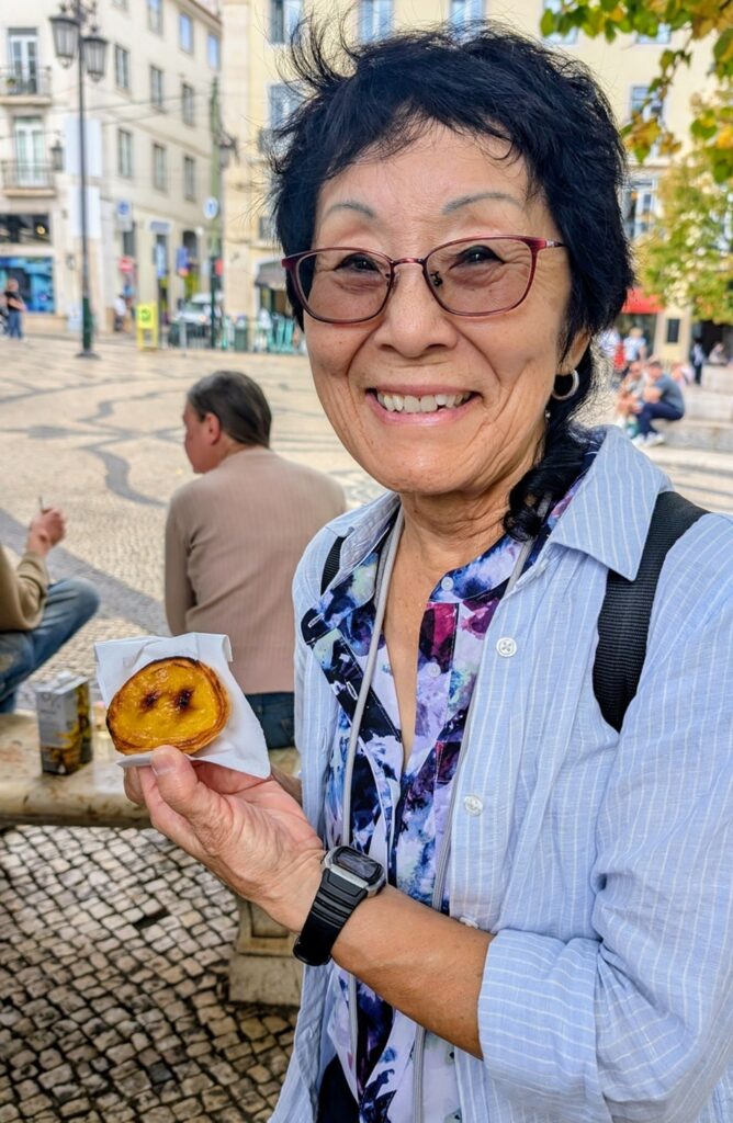 vegan tour group participant holding a vegan pastel de nata in lisbon