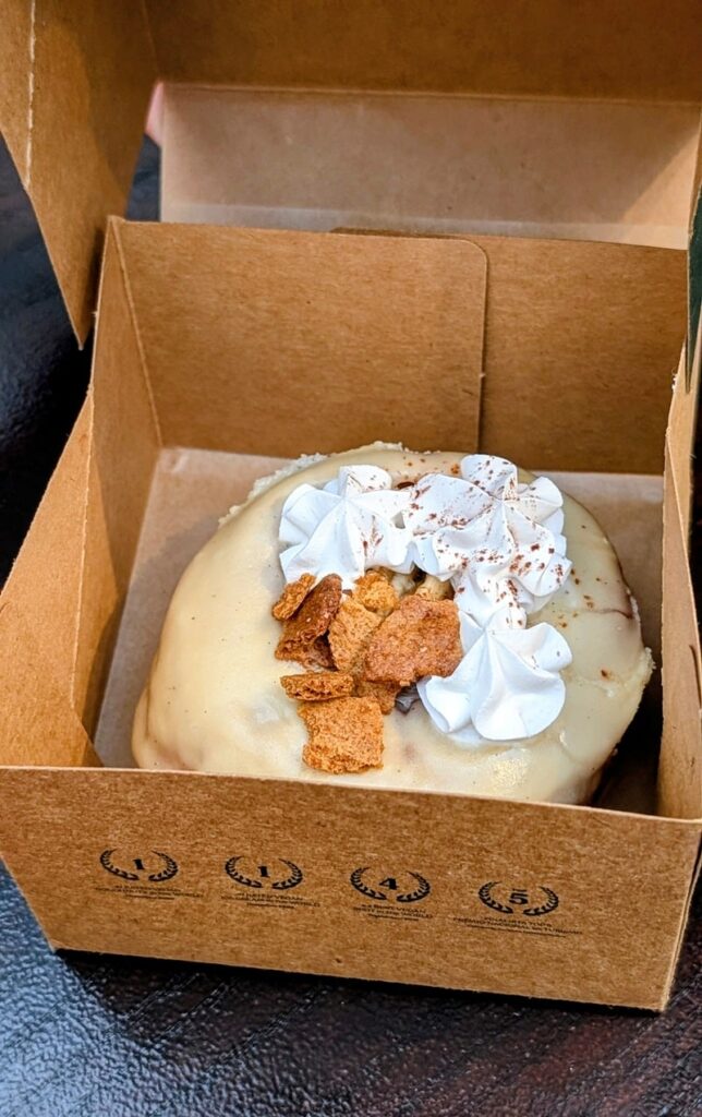 a small cardboard box with a single vegan banoffe donut