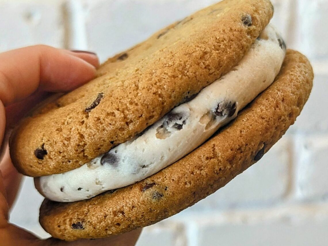vegan chocolate chip cookie sandwich with cream in the middle at a bakery in madrid
