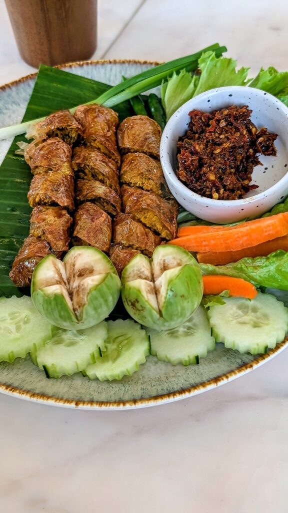 fried tofu skin rolls surronded by mixed veggies in bangkok