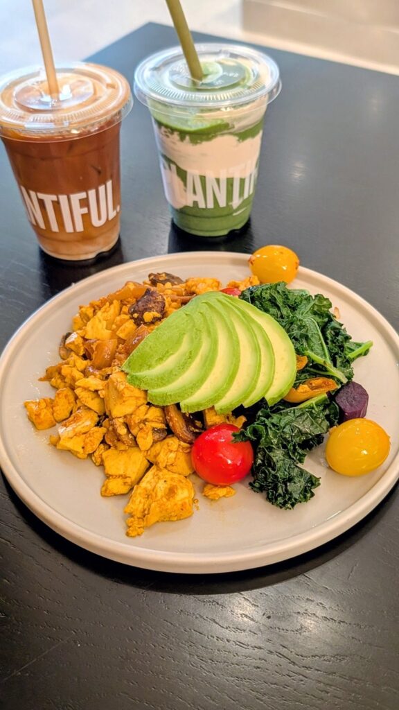 tofu scramble with mixed veggies and avocado with a coconut coffee and a green smoothie at Plantiful in bangkok
