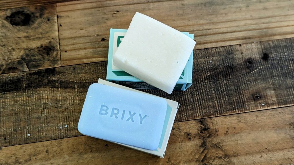 a brixy shampoo and conditioner bar out of the box on a wood table