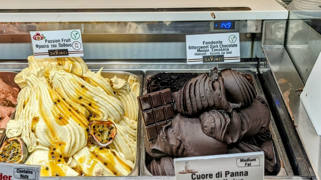 two large silver bins with vegan passionfruit and vegan dark bittersweet chocolate ice cream at davinci gelato in mykonos