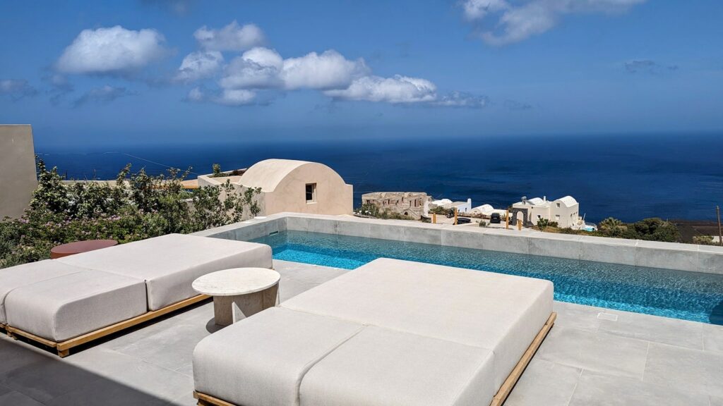 outdoor plunge pool with a view of the ocean at ethos vegan retreat in santorini