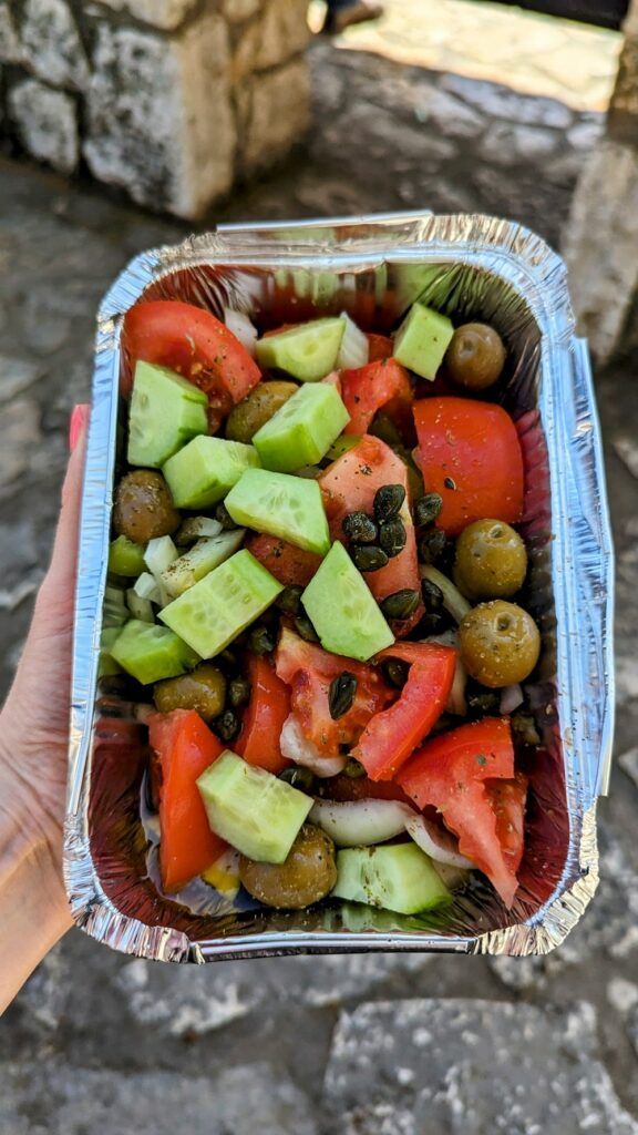 a traditional greek salad with chunks of cucumber and tomato without feta cheese