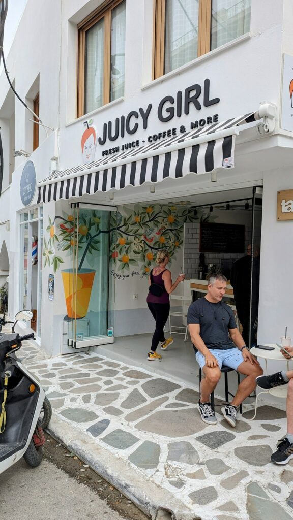 the outside of the black and white smoothie shop juicy girl in naxos