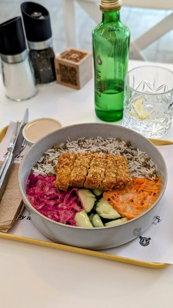 a large gray bowl filled with colorful veggies and crispy strips of vegan chicken at the rhino vegan street food restaurant in mykonos 