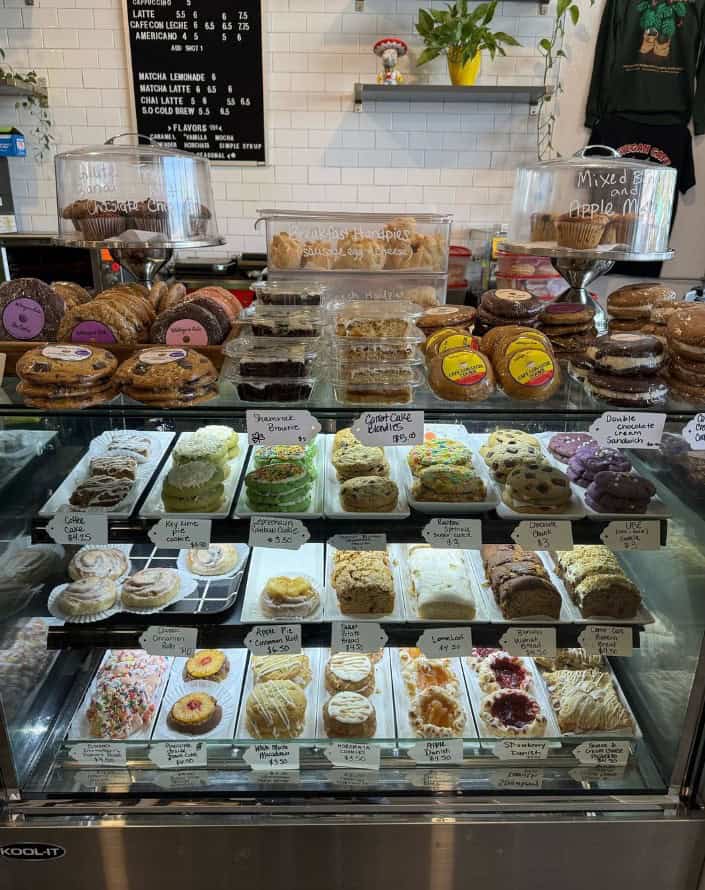 a bakery case filled with vegan cookies, bread, cake, donuts, and more at wevegan cafe in tampa