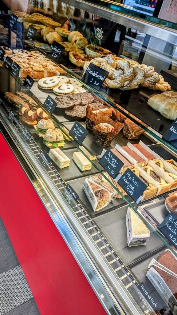 the bakery case stocked with cakes, bread, and desserts at enzian in zurich