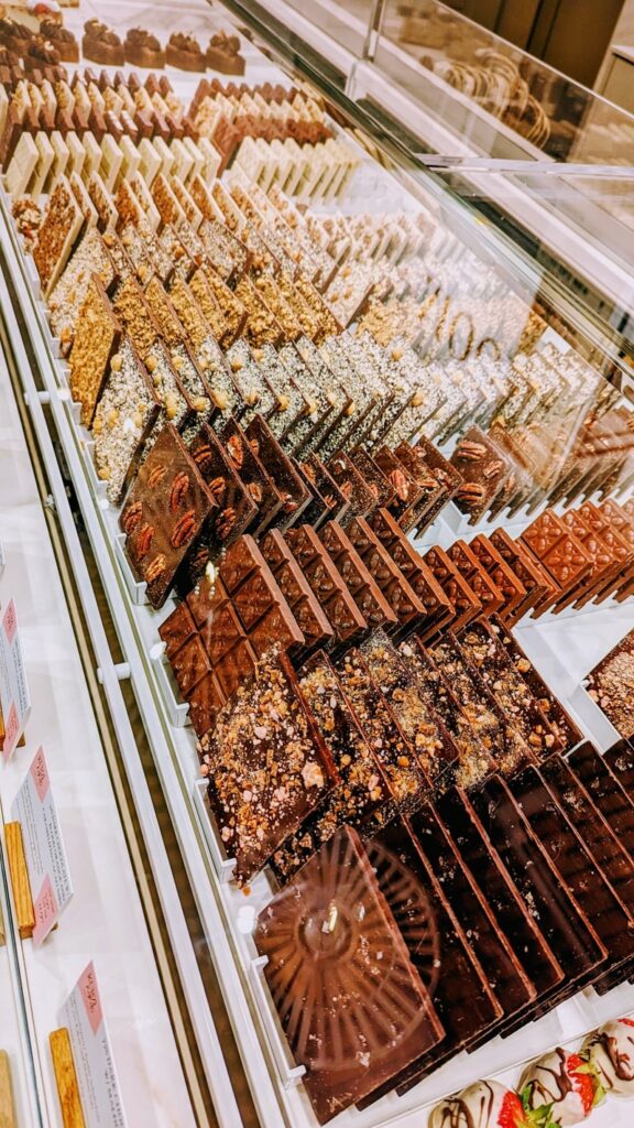 rows of vegan dark and milk chocolate in a pastry case at moon in zurich