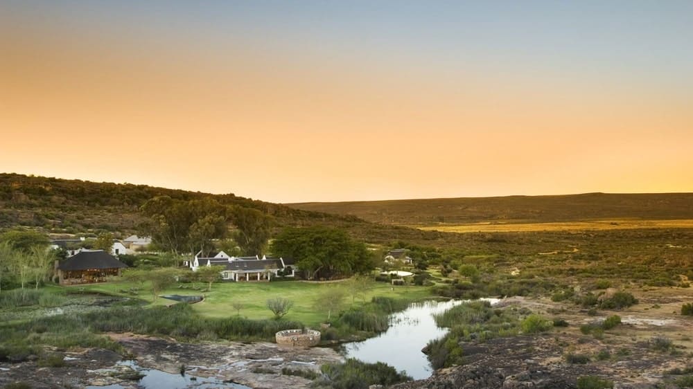 the orange sunset over the bushmans kloof african safari camp surronded by the cedarburg mountains in south africa