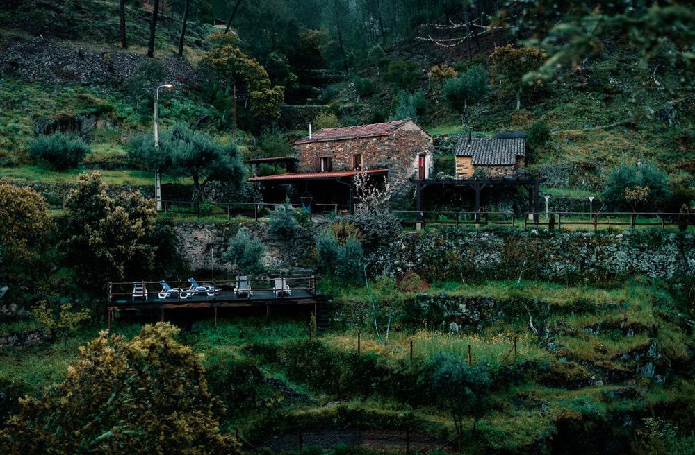 a landscape shot on a  dreary day of the outside of the eco and vegan-friendly retreat Vale de Moses surrounded by lush forest