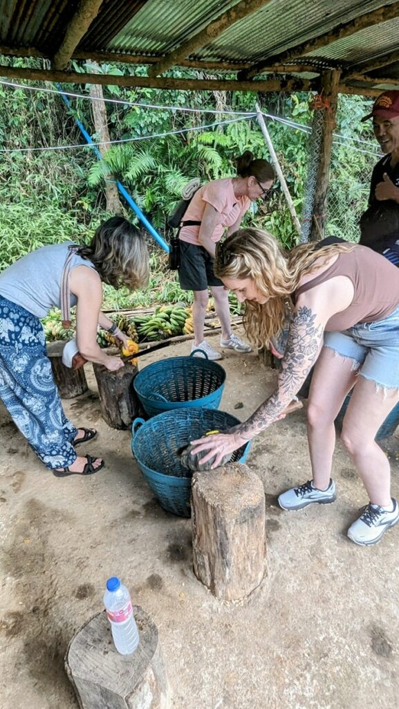 three women cutting up elephant snacks at changchill elephant sanctuary in thailand