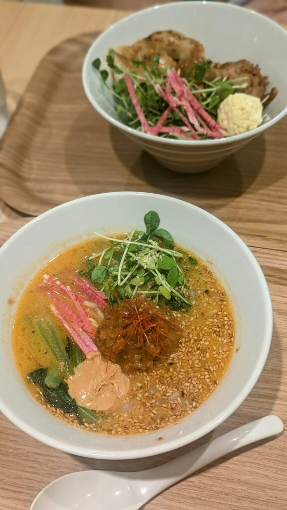 a bowl of vegan golden sesame ramen topped with minced soy meat and tahini at ts tan tan