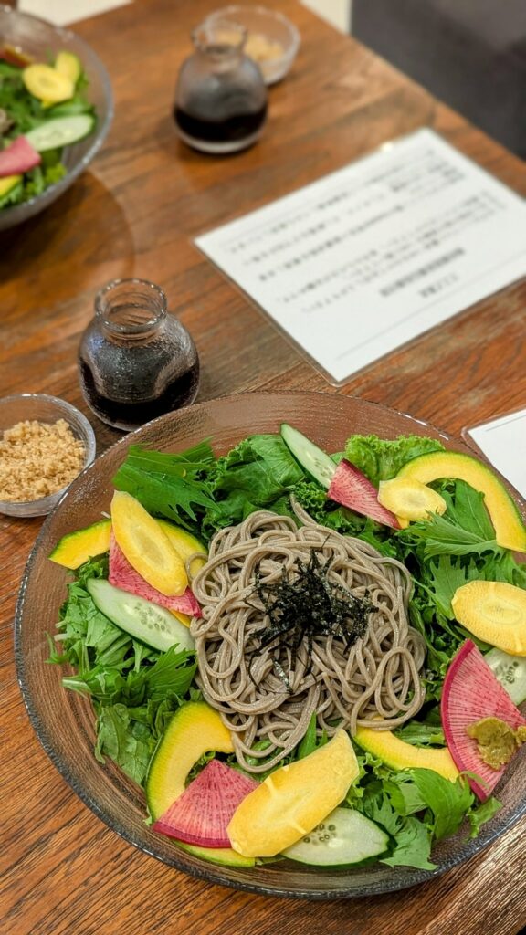 a vegan soba noodle salad with greens and sliced radish at choice in kyoto