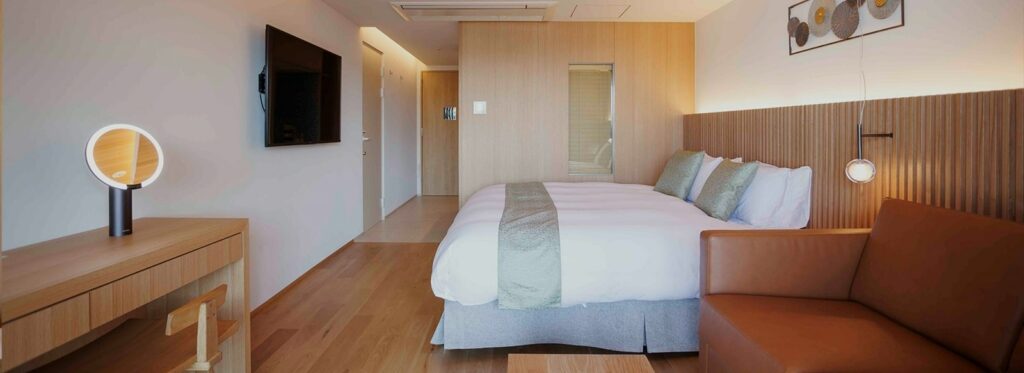 a modern guestroom with light wood and neutral tones at the gion elite terrace in kyoto